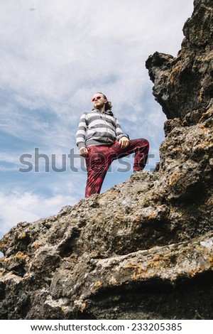man on the top of the lava mountain with a sky background