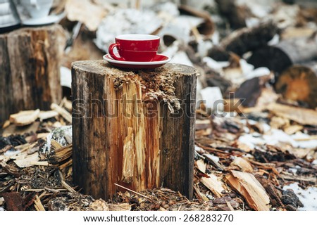 A cup of delicious morning black pour over coffee on the tree stump