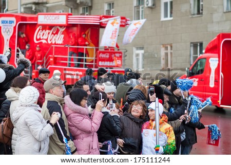 January 11, 2014, Saratov, Russia. Olympic Torch Relay Sochi 2014. Spectators photographed with a member of the relay