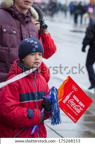 January 11, 2014, Saratov, Russia. Olympic Torch Relay Sochi 2014. Boy Watching The Transfer Of The Olympic Flame