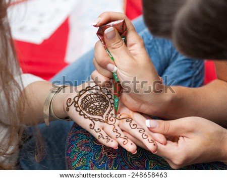 Woman applying henna