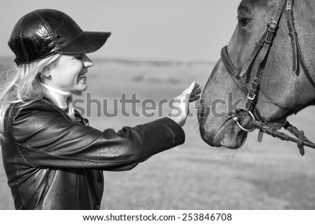 Horsewoman stroking the horse\'s head, Black and White