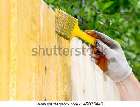 Man painting wooden furniture piece