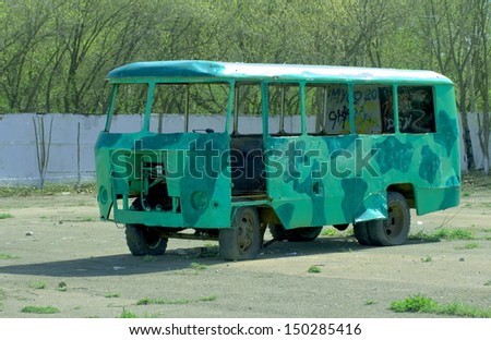 old abandoned bus wreck in arid mountainous