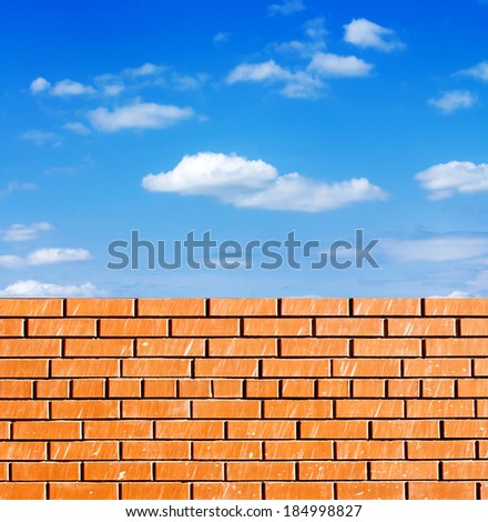 red brick wall against blue sky