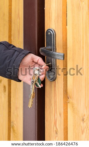 opening home door by bunch of keys close up