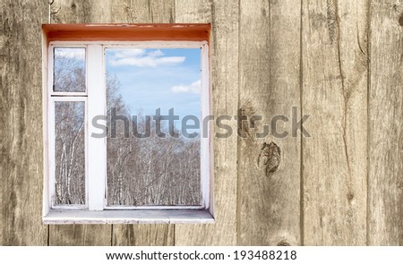 wooden wall with window outside forest clouds