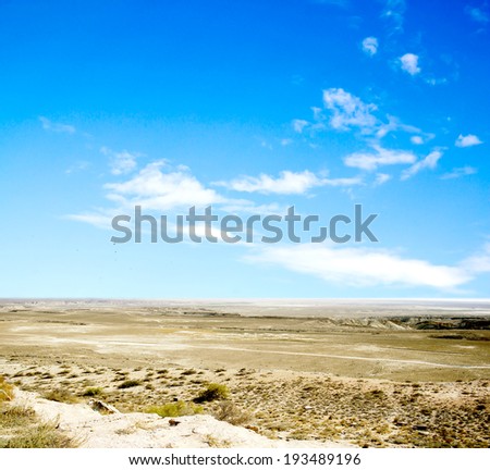 desert  against a blue sky with clouds