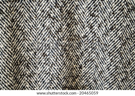 The fabric of a coat, is black a white pattern on all background