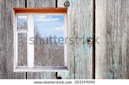 wooden wall with window outside forest clouds