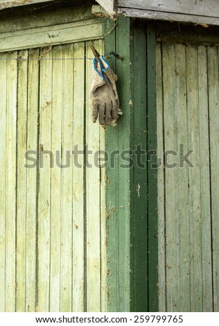 old glove on wooden background