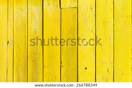 old wooden fence with yellow paint