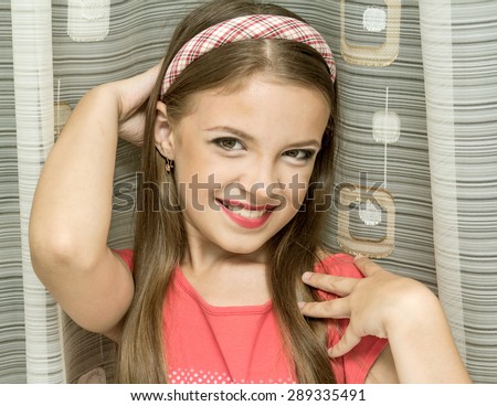 little girl with makeup portrait, smiling at the camera