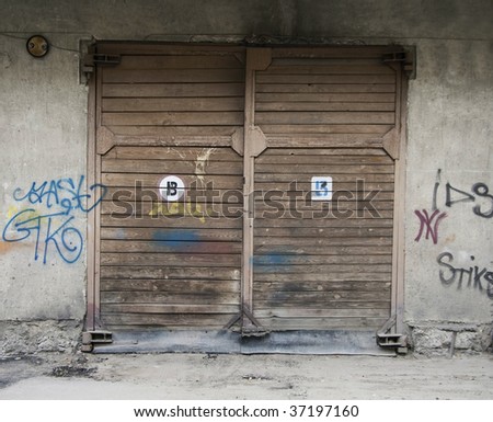wooden Garage Doors and wall with graffiti