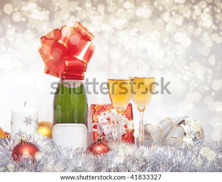 New Year composition with champagne, ball, garland, bow, glass, mirror and candle