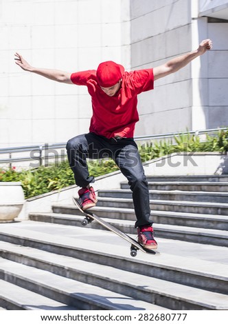 Skateboarder doing a skateboard jumping trick from  stairs