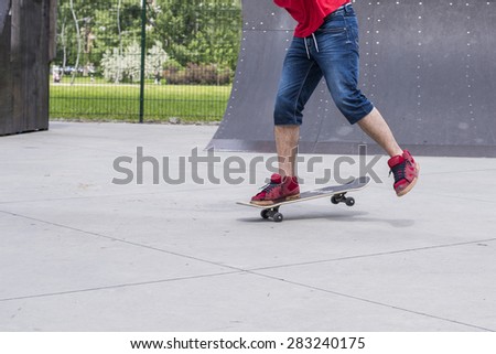 Close up of skateboarder doing a trick at skateboard park