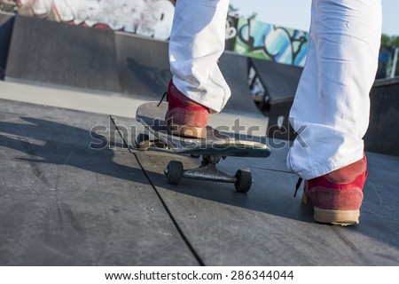 Skateboarder preparing to perform a skateboard trick at skate park