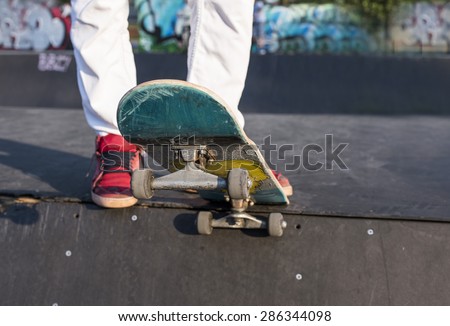 Skateboarder preparing to perform a skateboard trick at skate park