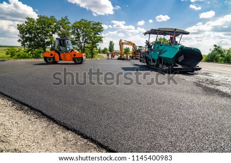 Laying a new asphalt on the road. Construction of the road.