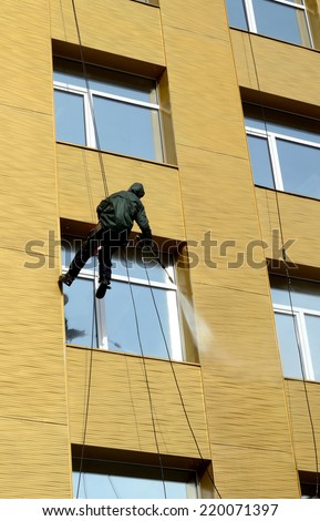 Worker washes windows