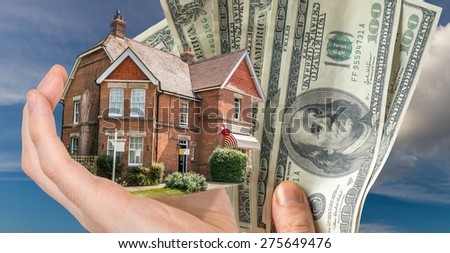 Hand holding house and money - sale of real estate