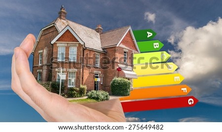 Hand is holding energy saving house with energy levels in background