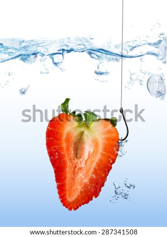 Strawberry is hooked as fishing lure on fishing hook under water