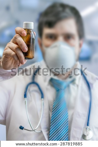Doctor holds cure in phial bottle
