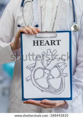 Doctor holds clipboard with heart diagram