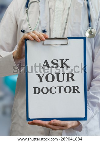 Practitioner doctor holds clipboard and gives advice to ask your doctor