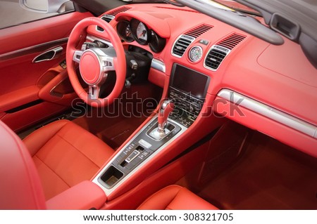 Red luxury car Interior - steering wheel, shift lever and dashboard
