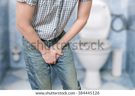 Man with prostate problem in front of toilet bowl. Incontinence