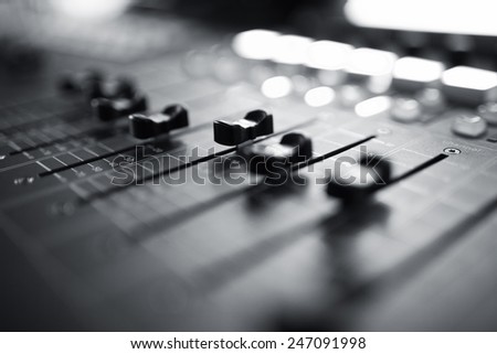 Professional audio mixing console with faders and adjusting knobs,TV equipment Black and White selective focus