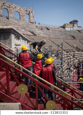 VERONA, ITALY - MAY 10:  Workmen assembling a stage at the arena of Verona on May 10, 2012. It is the second largest roman amphitheater in the world and famous for its opera performances.
