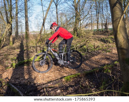 Almere, Netherlands - Feb. 3, 2014: Mountain Biker Test Riding A Brand New State Of The Art Electric Powered Mountainbike Which Uses A Motor And Provides A Smooth And Easy Ride On Rough Terrain