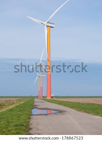 Brightly colored wind turbine in Dutch landscape