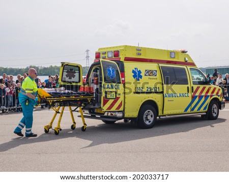 ALMERE, NETHERLANDS - 12 APRIL 2014: Medical services at work in an enacted emergency scene during the first National Security Day held in the city of Almere