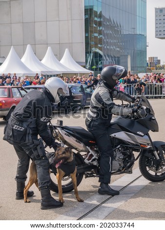 ALMERE, NETHERLANDS - 12 APRIL 2014: Members of a SWAT team and dog during a demonstration on the first National Security Day held in the city of Almere