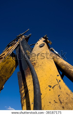 Close up of mechanical arm of backhoe tractor.