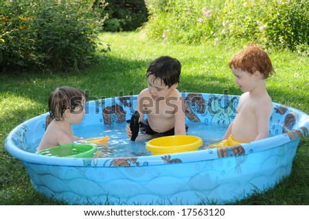 Three little boys play in a wading pool, making up stories about a favorite dolphin