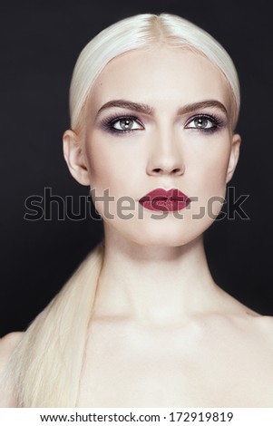Fashion stylish beauty portrait. Professional model. Professional make up./Portrait of beautiful girl with blonde hair close up isolated on black background