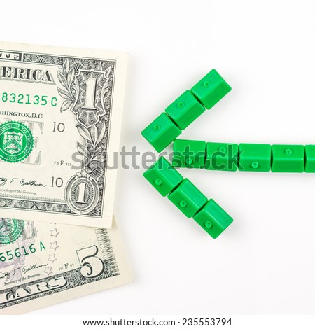 arrow made of miniature green houses is directed to the dollar banknote