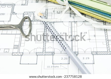 construction plan closeup with old key, pencil and hard desks