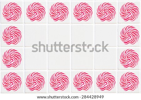 white ceramic tile with 24 squares in rectangular form with red lollipop pattern