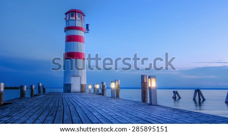 red striped lighthouse in one summer evening somewhere in Europe