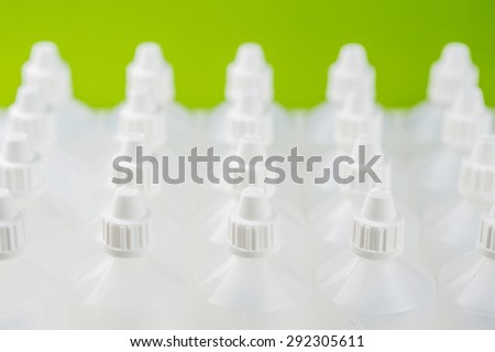 white translucent bottles used in homeopathy with blurred bottles background