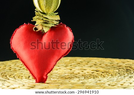 red heart decoration on background made of dry banana leaf with circle texture and black color