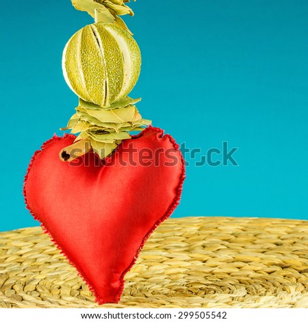 red heart decoration on background made of dry banana leaf with circle texture and turquoise color