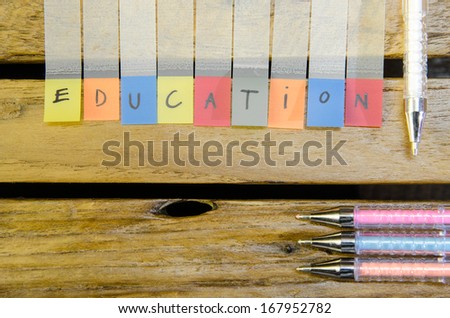 Education alpabet with color pen on wood pattern background